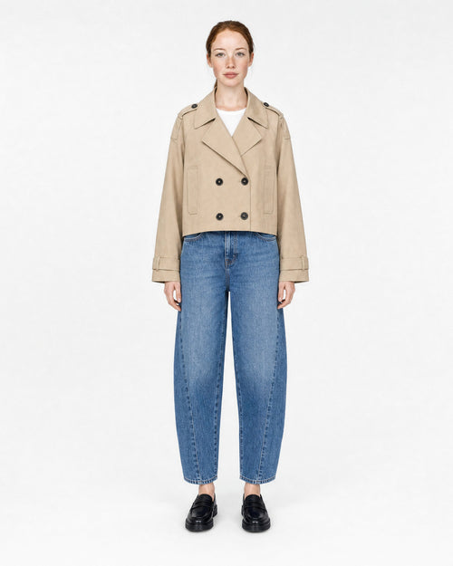 cropped trench coat in beige, buttoned, front view on model