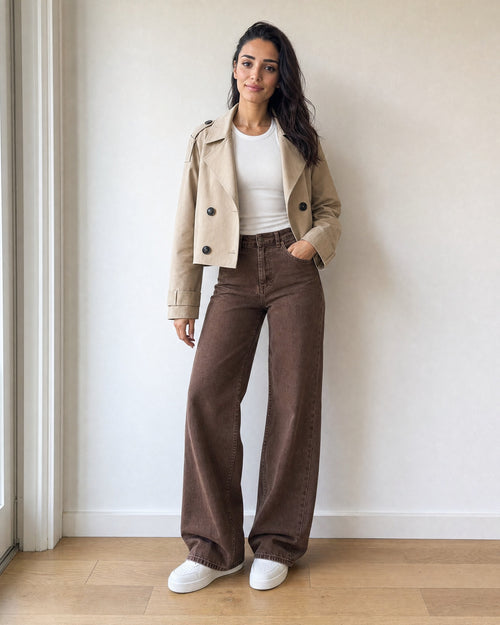 beige cropped trench coat worn open over a white rib tank top